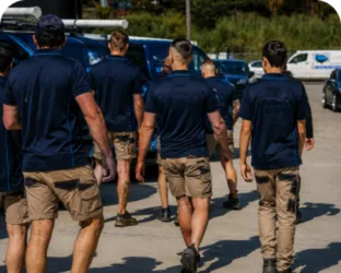 Plumbers walking to their service vans on a Revesby job
